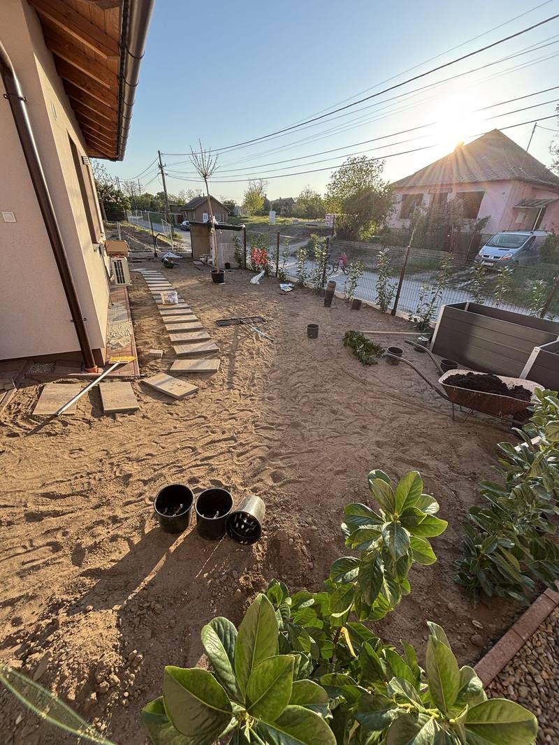 Garden construction in progress: spreading the sub-base, laying slabs and new planting